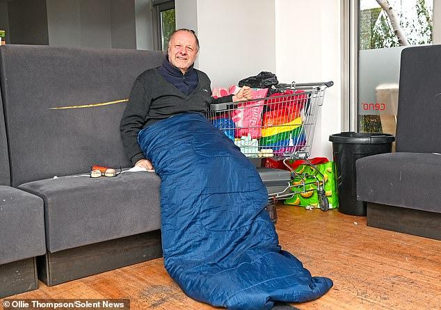 Homeless people escape the freezing cold by taking over restaurant that was forced to close because of migrant hotel next door - as volunteers blast government for 'double standards'